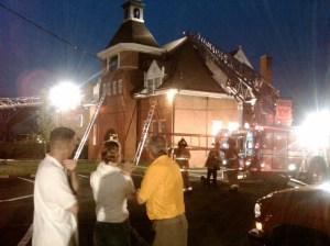 museum surrounded by fire trucks